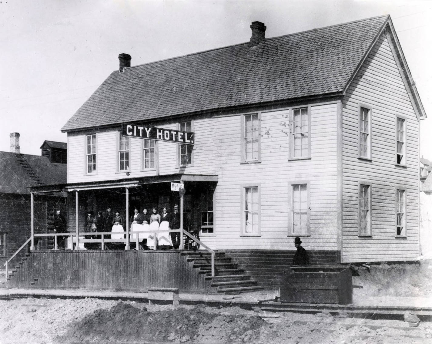 People standing on porch of Moscow City Hotel. Moscow, Idaho.
