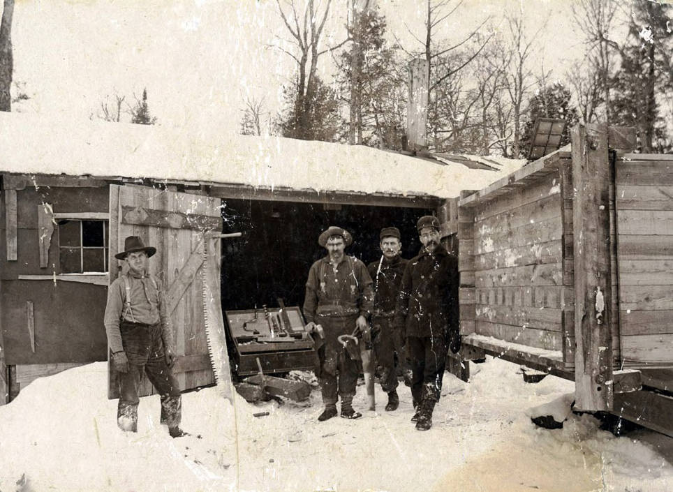 Men standing by carpenters shop. Logging camp near Elk River, Idaho.