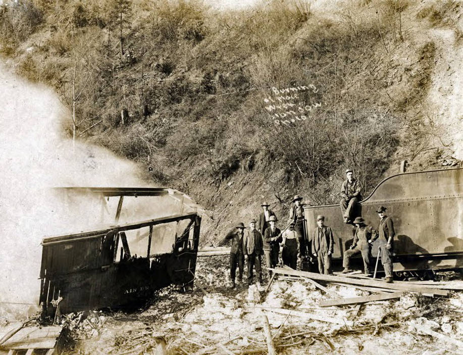 Boxcar burning after train wreck. Mace, Idaho.