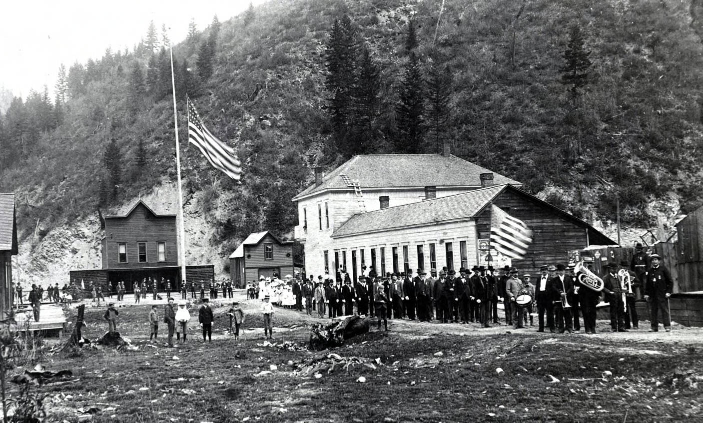 View of 4th of July parade looking north on 7th Street toward fire station. Wallace, Idaho.